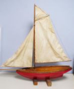 PRE-WAR POND YACHT, hollow hulled, top sailed rig with three sails, red painted hull, varnished