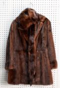 LADY'S DARK BROWN MINK THREE-QUARTER LENGTH COAT with revered collar, double breasted two button