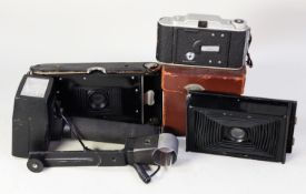 A LEATHER CASED VINTAGE PATHESCOPE MOTOCAMERA 'B' HANDHELD MOTION PICTURE CAMERA, with three extra