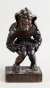 PROBABLY BLACK FOREST LATE 19TH CENTURY CARVED OAK FIGURE OF A MEDIAEVAL JESTER, in a crouching