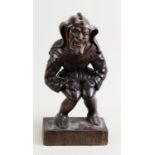 PROBABLY BLACK FOREST LATE 19TH CENTURY CARVED OAK FIGURE OF A MEDIAEVAL JESTER, in a crouching