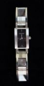 LADY'S BURBERRY QUARTZ STAINLESS STEEL BRACELET WATCH with small oblong black dial with four batons,