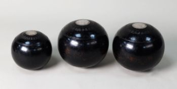 THREE INTER-WAR YEARS BIASED WOODEN BOWLS each inset with silver roundels, the two larger bowls