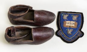 PAIR OF EARLY TWENTIETH CENTURY CHILD'S TAN LEATHER CLOGS, leather strap and black bead fastening, 6