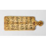 RARE EIGHTEENTH CENTURY BONE HORNBOOK OR TEACHING AID, of paddle form on each side incised with