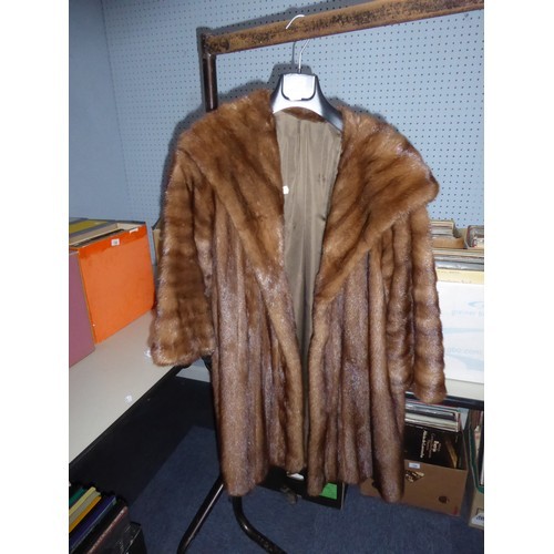 LIGHT BROWN FULL-LENGTH FUR COAT with deep shawl collar, slit pockets, interior silk tie fastening