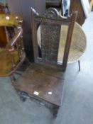 ANTIQUE CARVED OAK SIDE CHAIR, with stylised tall flowers carved to the splat, later solid seat