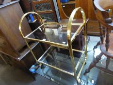 STYLISH GILT METAL FRAMED TWO TIER TEA TROLLEY, WITH TWO SMOKED GLASS SHELVES