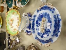 VICTORIAN POTTERY FLOW BLUE DECORATED OVAL TUREEN AND COVER AND AN OVAL STAND STAINED TO MATCH; A