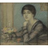 EDWARD RIDLEY (1883 - 1946) PASTEL DRAWING Young woman seated at a table Unsigned 10 1/4in x 11 1/