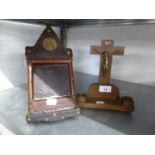 AN OAK AND BRASS CRUCIFIX, ON OBLONG BASE WITH TWO BRASS MOUNTED CANDLE SCONCES AND A LEATHER