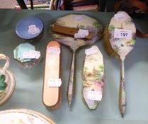 A TORTOISESHELL AND PASTE HAIR COMB; A PICTORIAL ENAMELLED DRESSING TABLE BRUSH SET OF THREE PIECES;