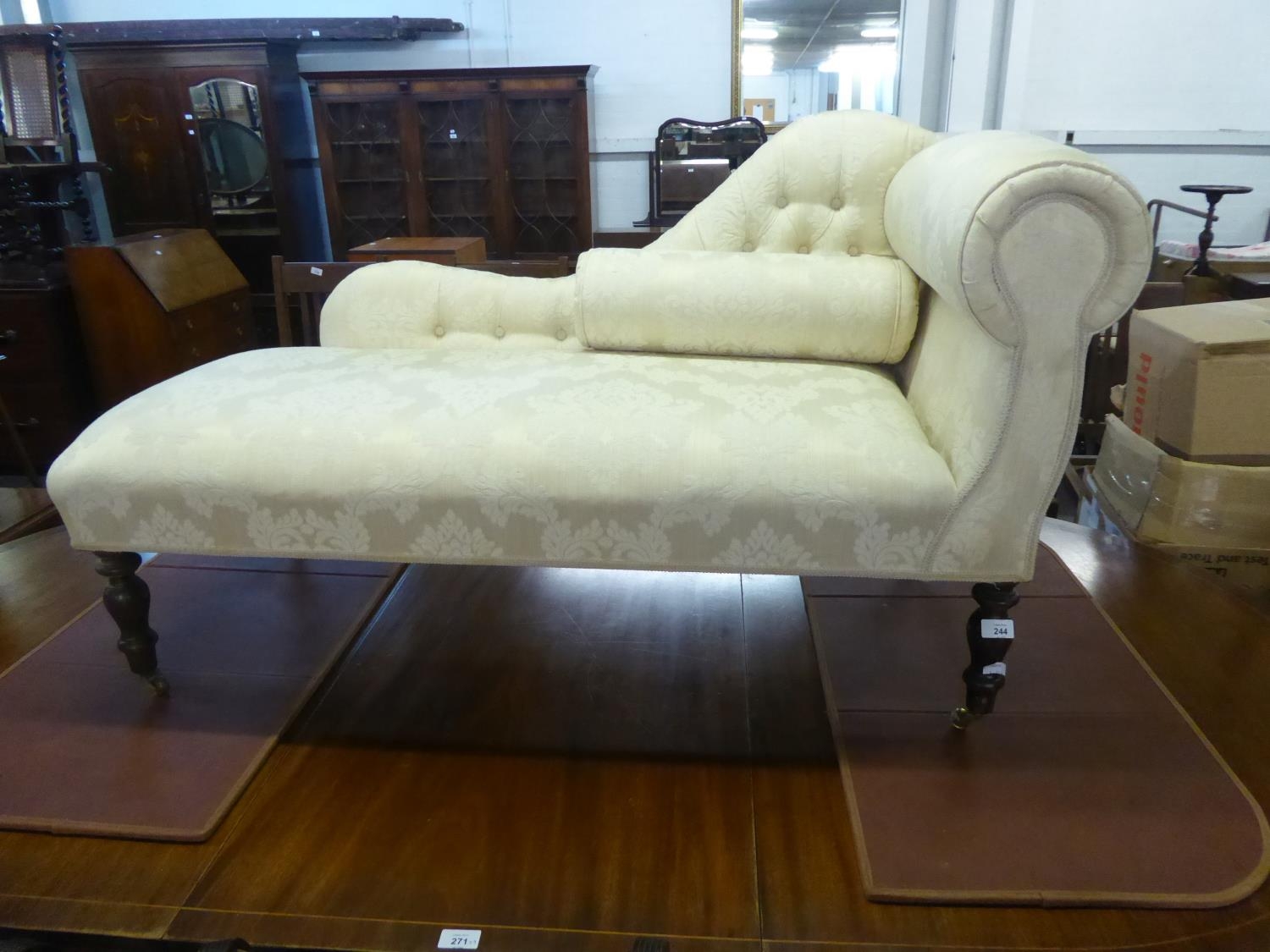 SMALL VICTORIAN STYLE FULLY UPHOLSTERED CHAISE LONGUE on turned legs, 51" (129.5cm) long C/R- good