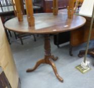 A NINETEENTH CENTURY OAK CIRCULAR TILT-TOP TABLE, RAISED ON TRIPOD BASE