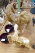 TWO GRADUATED CARVED WOOD TRUMPETING ELEPHANTS (a.f.) (2)