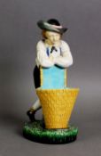 MINTON MAJOLICA FIGURE OF A BOY WITH GRAPE BASKET AND VINE, model number 421, one of a pair; 9 1/