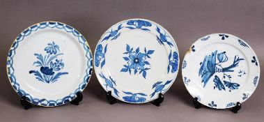 THREE 18TH CENTURY ENGLISH DELFT PLATES, including a London example c.1730; 9" (23 cm) and