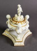 A ROYAL WORCESTER STYLE BLANC DE CHINE DESK TIDY, with Egyptian Style Caryatid tripartite supports
