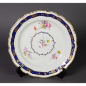 LATE 18TH CENTURY DERBY PORCELAIN SERPENTINE CABINET PLATE, decorated by Edward Withers in floral