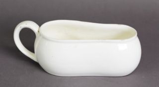 NINETEENTH CENTURY CREAMWARE POTTERY BOURDALOUE, of waisted form with moulded scroll handle, 9 ½” (