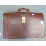 A LARGE BROWN HARD LEATHER BRIEFCASE