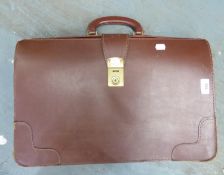 A LARGE BROWN HARD LEATHER BRIEFCASE