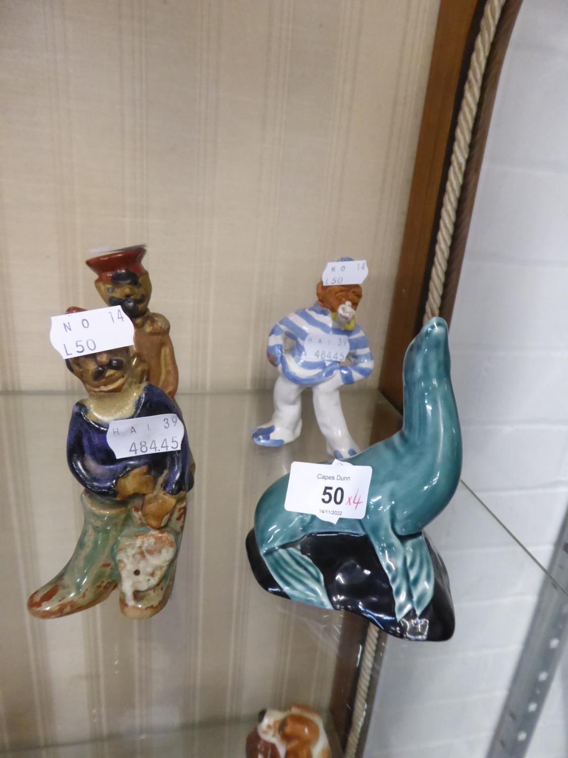 POOLE GREEN GLAZED POTTERY MODEL OF A SEAL; TINTAGEL STUDIO POTTERY FIGURE OF A SAILOR AND A TWO