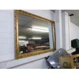 LARGE BEVELLED EDGE OBLONG GILT FRAMED MIRROR, 106cm x 78cm AND A FLORAL DECORATIVE FRAMELESS WALL