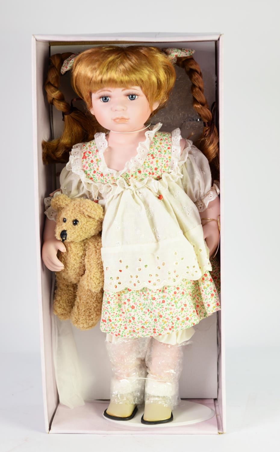 BOXED LEONARDO COLLECTION CERAMIC HEADED COLLECTOR'S DOLL with pigtails and holding a teddy bear,