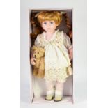 BOXED LEONARDO COLLECTION CERAMIC HEADED COLLECTOR'S DOLL with pigtails and holding a teddy bear,