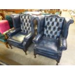 A PAIR OF MODERN BLUE LEATHER CHESTERFIELD WING ARMCHAIRS, ON CABRIOLE LEGS (2)