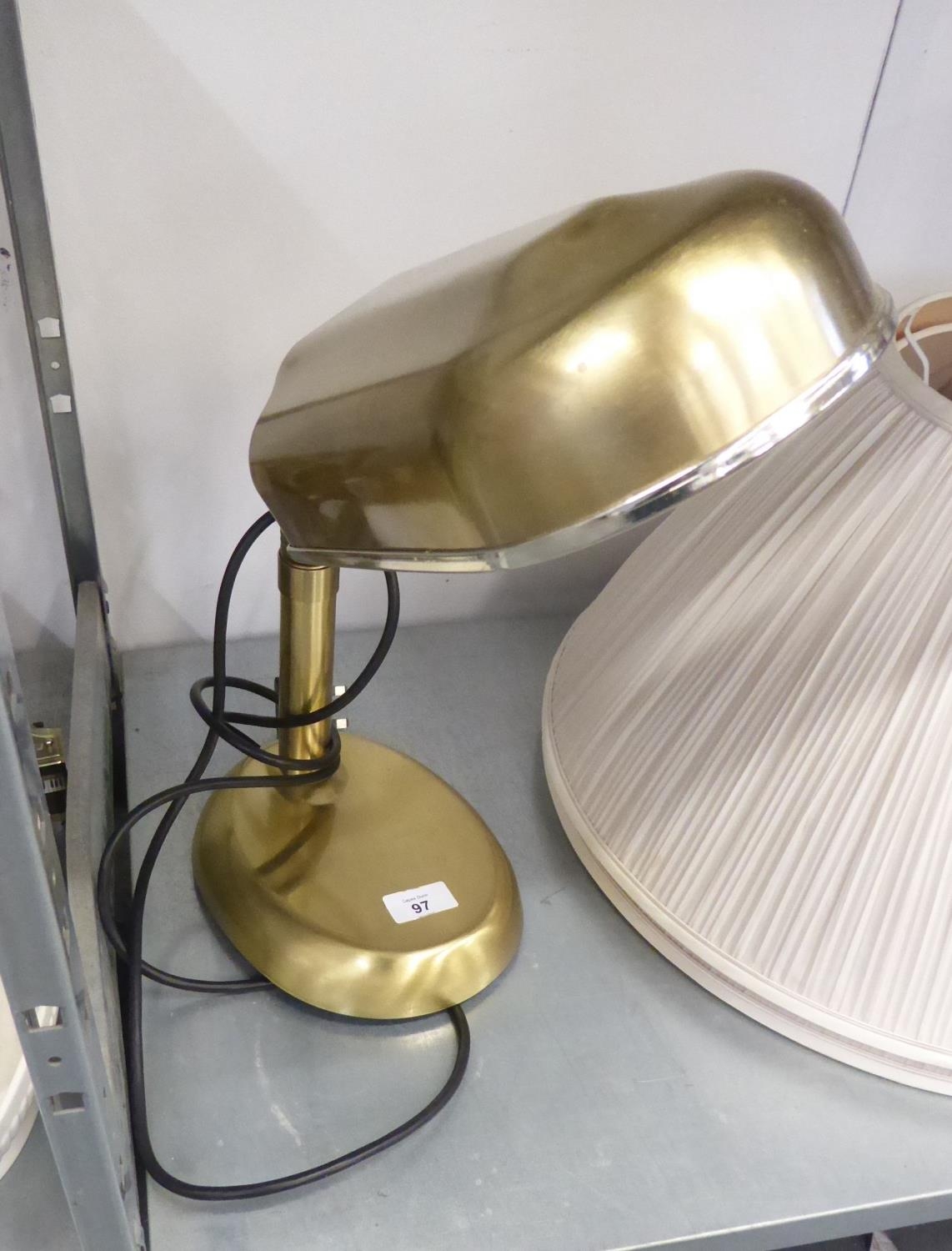 A SATIN BRASS FINISH ADJUSTABLE TABLE TOP READING LAMP, WITH METAL SHADE TO THE FLUORESCENT BULBS,