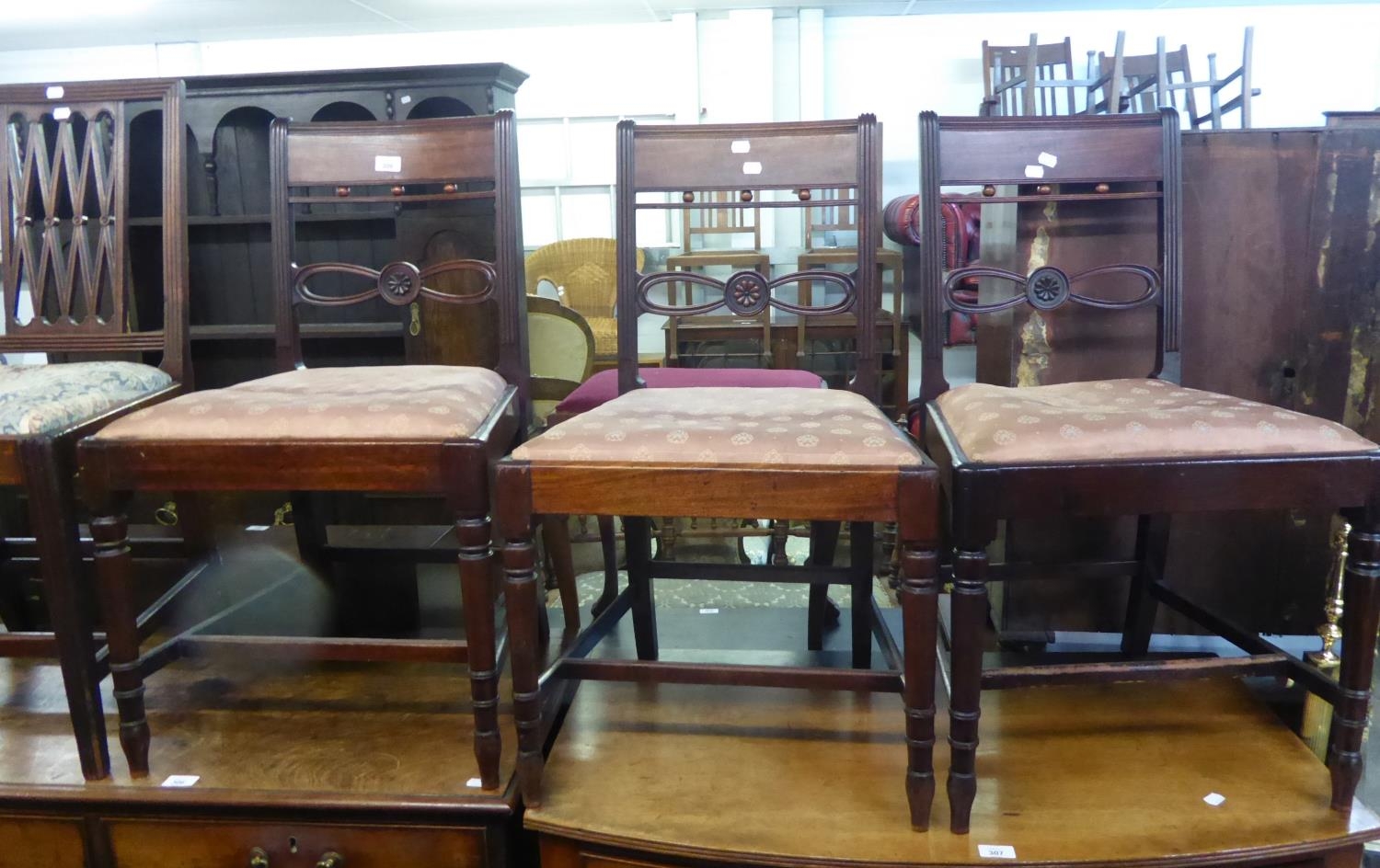 A SET OF THREE MAHOGANY DINING CHAIRS WITH BOW DESIGN DECORATION TO THE BACK (A.F.), AND A SET OF