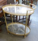 A GOLD COLOURED GALLERIED DRINKS TROLLEY, WITH MIRRORED OVAL SHELVES, 30 3/4" (78cm) WIDE