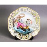 19TH CENTURY GERMAN PORCELAIN RETICULATED CABINET PLATE, the central hand-painted reserve