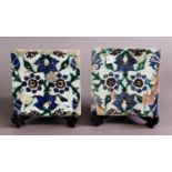 A PAIR OF ISNIK TILES, decorated with blue, green and brick red floral decoration to a tin glaze, 6"