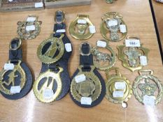 ELEVEN VARIOUS HORSE BRASSES LOOSE, AND ON LEATHER STRAPS (11)