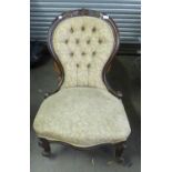 A VICTORIAN SPOON BACK NURSING CHAIR WITH BUTTON BACK, RAISED ON SHAPED FRONT LEGS