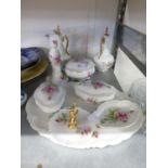 A WHITE CHINA DRESSING TABLE TRINKET SET, PRINTED WITH A PINK ROSE, NINE PIECES INCLUDING THE OVAL