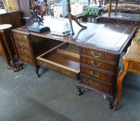 MID TO LATE TWENTIETH CENTURY MAHOGANY PEDESTAL DESK, THE TOP WITH THREE INSET TOOLED BURGUNDY