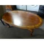 A LARGE OVAL COFFEE TABLE ON CABRIOLE LEGS