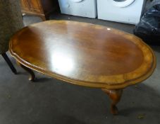 A LARGE OVAL COFFEE TABLE ON CABRIOLE LEGS