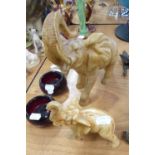 TWO GRADUATED CARVED WOOD TRUMPETING ELEPHANTS (a.f.) (2)