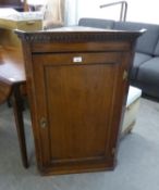 AN ANTIQUE OAK FLAT FRONTED CORNER CUPBOARD WITH PANEL DOOR