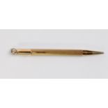 9ct GOLD SLIM PROPELLING PENCIL with engine turned decoration, ring hanger to the top, 4in (10cm)