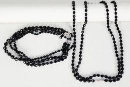 TRIPLE STRAND NECKLACE OF FACETED ROUND JET BEADS, each strand with uniform beads, but the strands