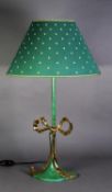 A GREEN ENAMELLED METAL TABLE LAMP, with gilt metal large ribbon bow decoration and the shade, 31 ½"