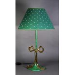 A GREEN ENAMELLED METAL TABLE LAMP, with gilt metal large ribbon bow decoration and the shade, 31 ½"