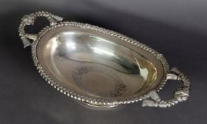 CONTINENTAL ENGRAVED SILVER COLOURED METAL TWO HANDLED PEDESTAL DISH, of oval form with braided