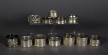 ELEVEN VICTORIAN AND LATER SILVER NAPKIN RINGS, including a FLORAL ENGRAVED PAIR, together with an